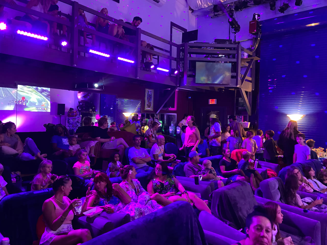 Visitors gathered on couches and the mezzanine in Fuzz Box’s illuminated lounge